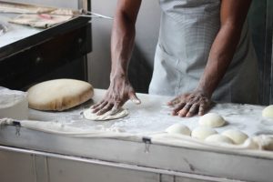 man-preparing-dough-for-bread-3218467